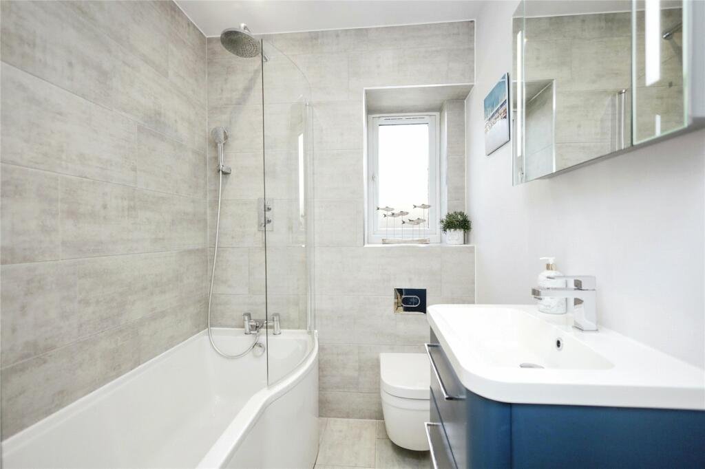 Robins Nest, Broad Oak: family bathroom with bath and shower over, by Bramall Homes