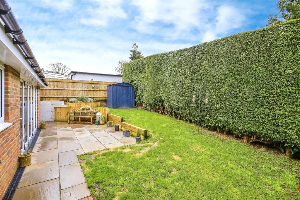 Robins Nest, Broad Oak: lawn and paved patio behind the bungalow, by Bramall Homes