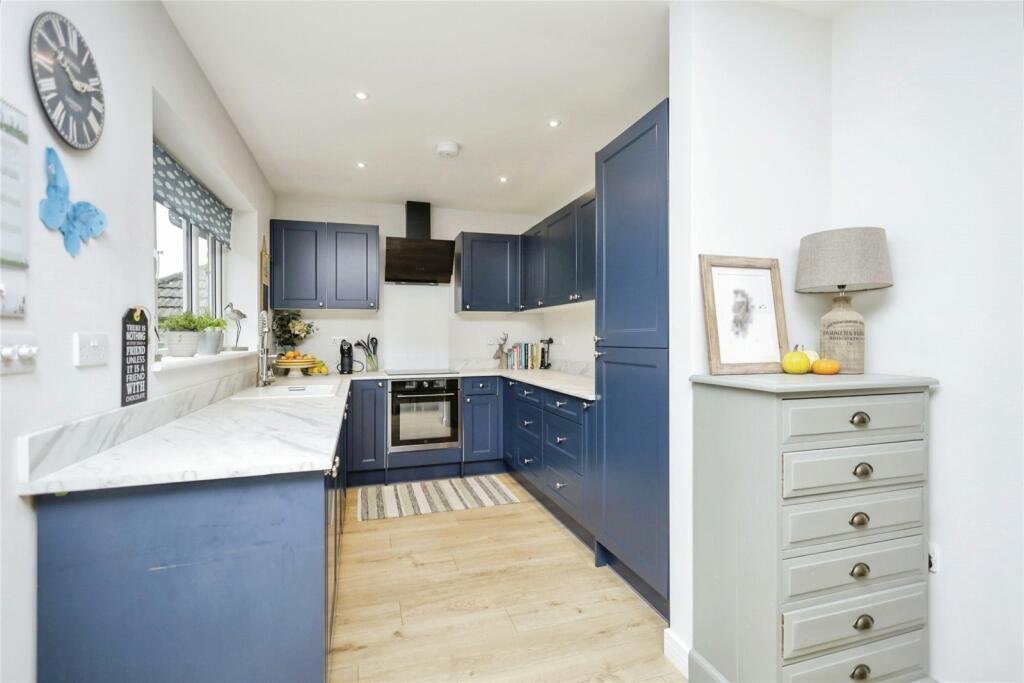 Robins Nest, Broad Oak: navy shaker kitchen with white worktops, by Bramall Homes