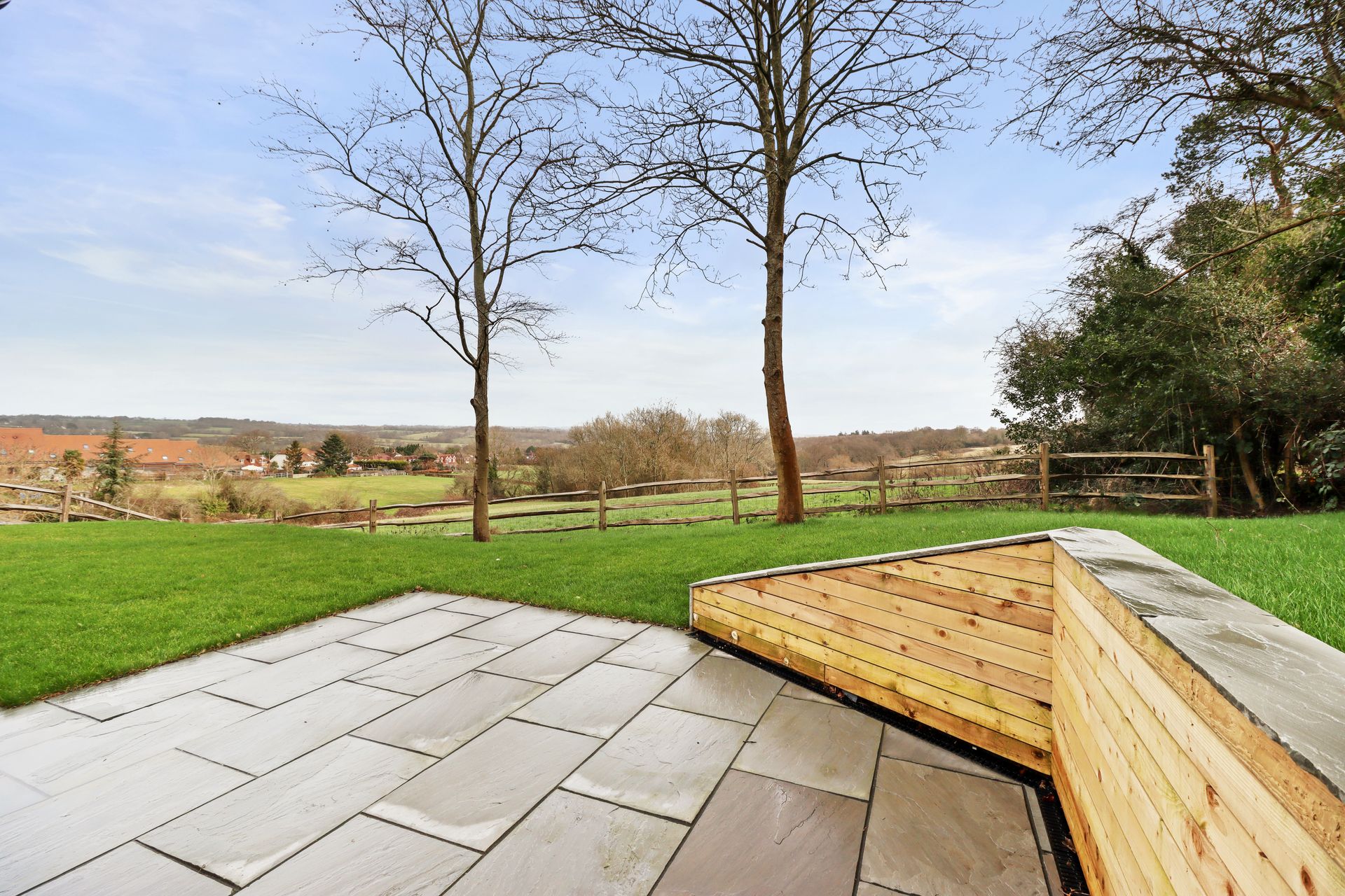 Bramley Barn, Burwash: patio with an open outlook over the Weald, by Bramall Homes