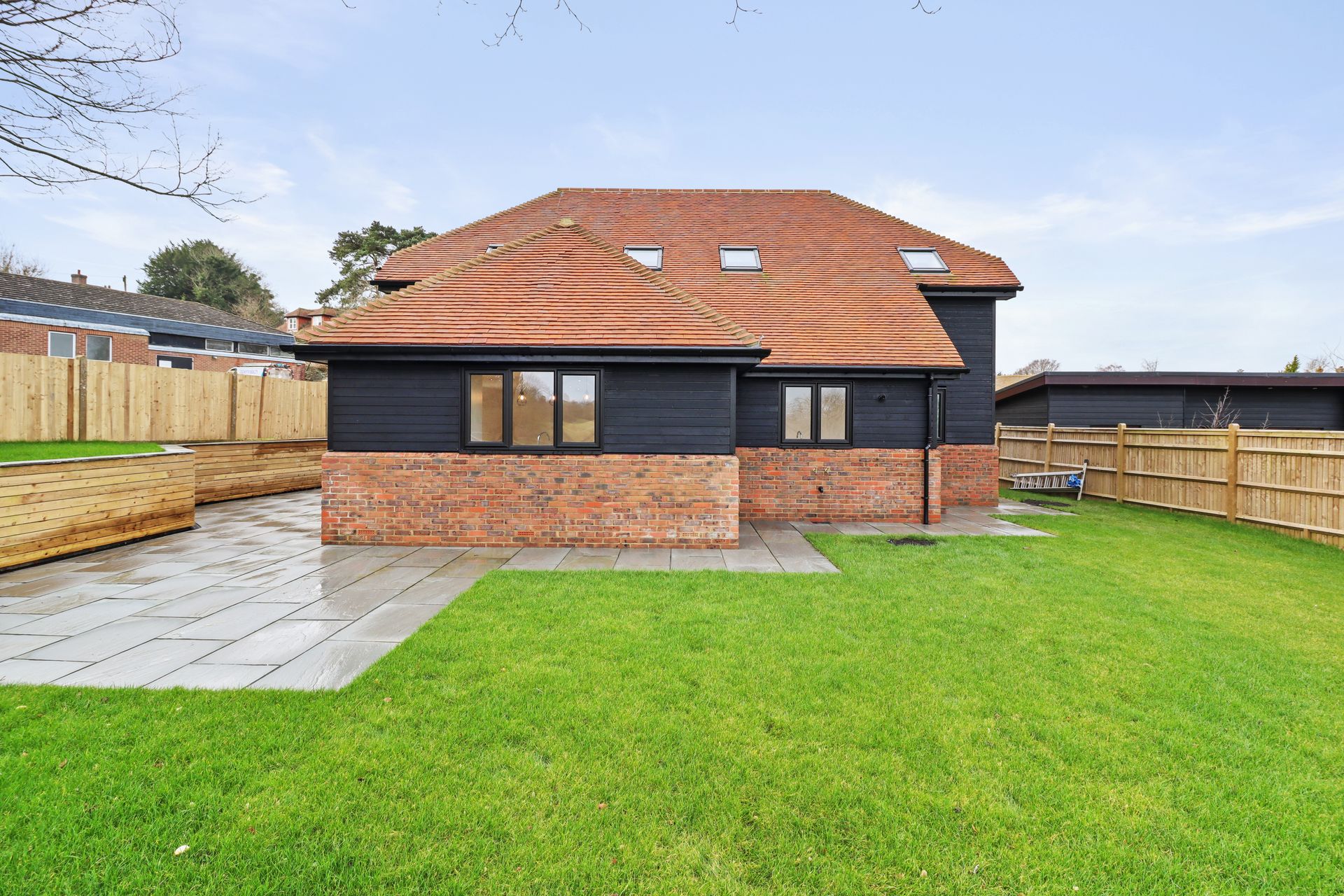 Bramley Barn, Burwash: rear elevation from the turfed garden, by Bramall Homes