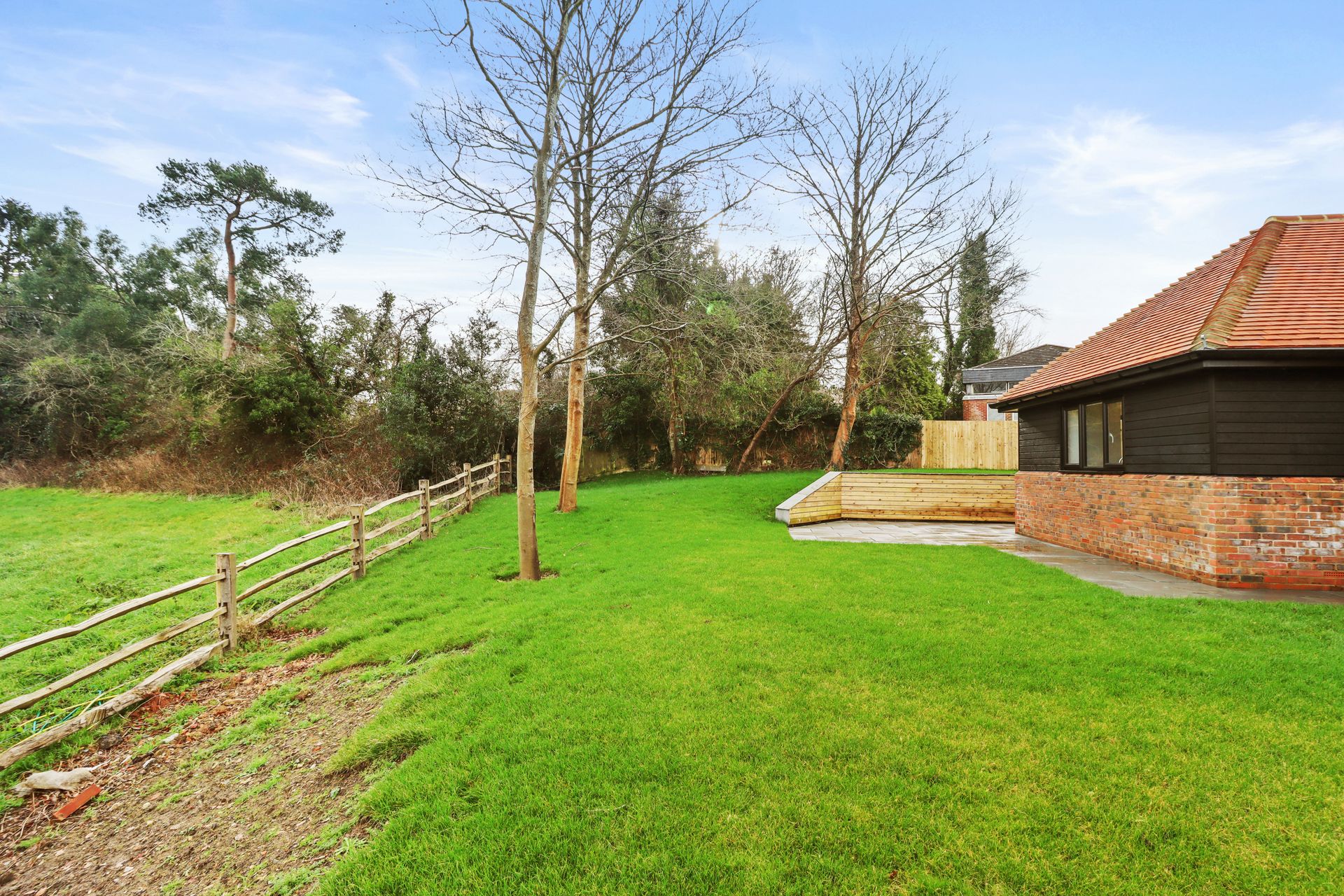 Bramley Barn, Burwash: the completed house in its rural setting, by Bramall Homes
