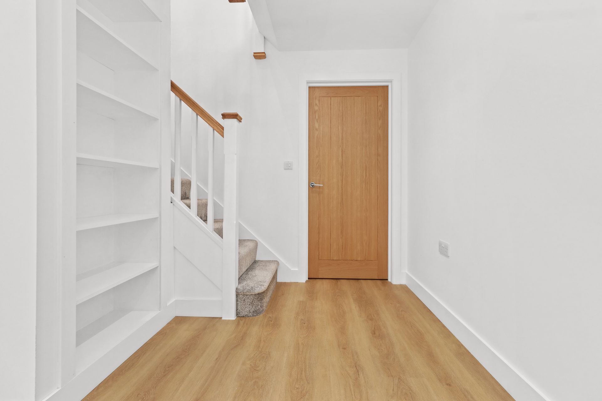 Bramley Barn, Burwash: oak staircase and built in shelving, by Bramall Homes