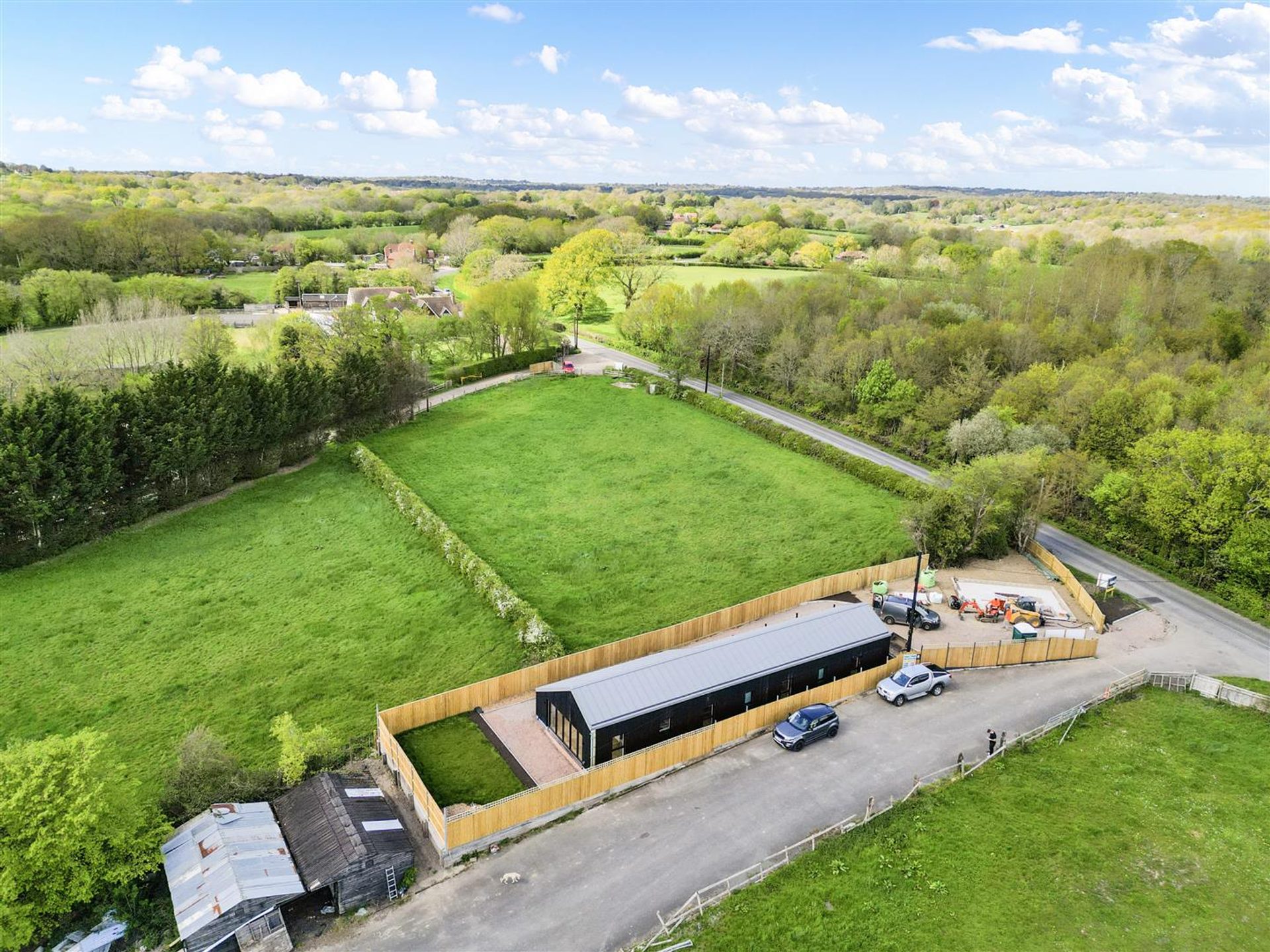 Bridlewood Barn, Horam: aerial view of the completed bungalow and its outlook over the Weald, by Bramall Homes