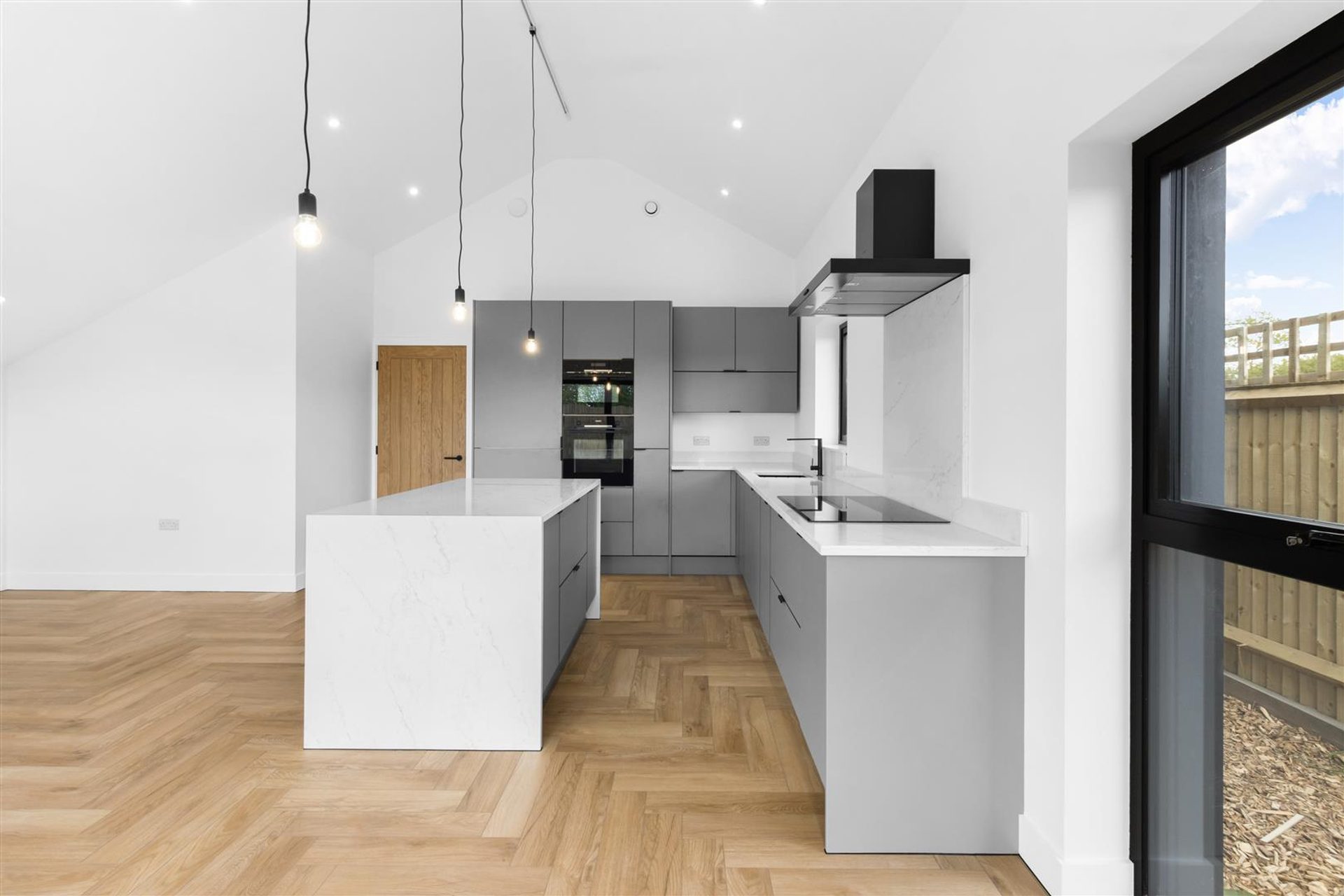 Bridlewood Barn, Horam: kitchen run with window over the sink, by Bramall Homes